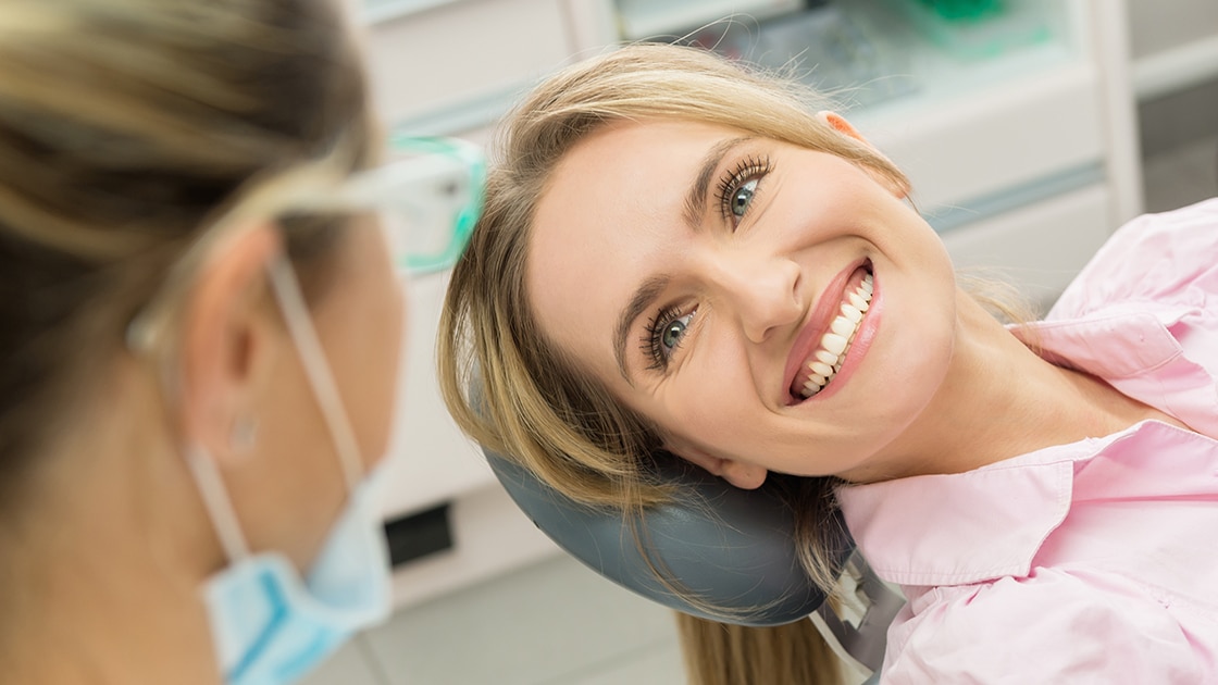 Patient Smiling at Dental Assistant